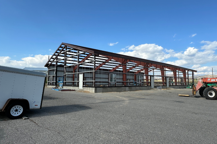the Career Technology Education (CTE) building is framed with metal framework and a construction vehicle is parked nearby